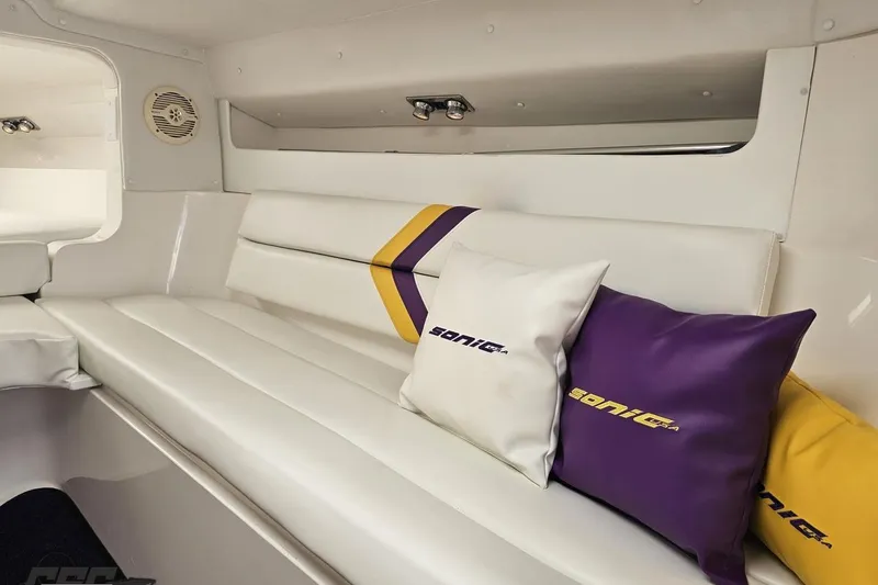 Slide: The Image of Interior of 2003 Sonic USA 31SS boat with white seating and branded cushions. - 86