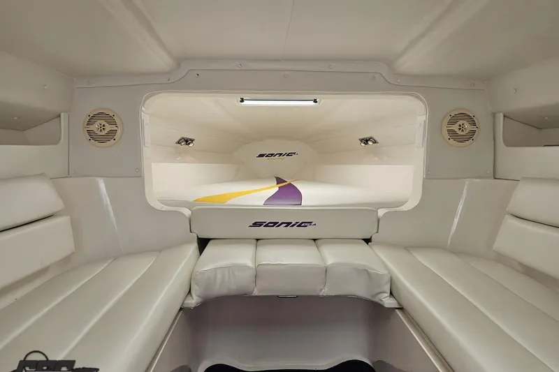 Slide: The Image of Interior of 2003 Sonic USA 31SS boat with white seating and speakers. - 87