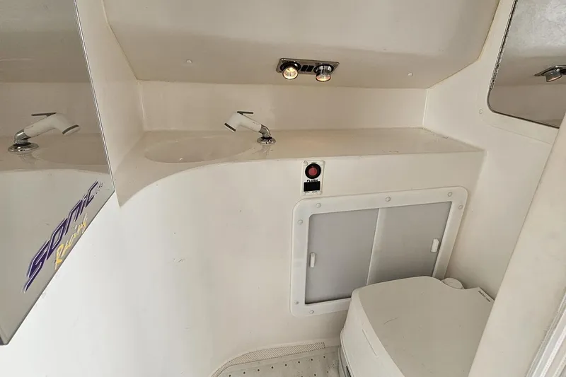 Slide: The Image of 2003 Sonic USA 31SS boat bathroom with sink, mirror, and storage cabinet. - 89
