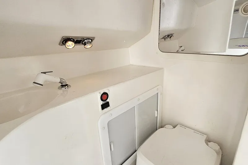 Slide: The Image of 2003 Sonic USA 31SS boat bathroom with sink, mirror, and toilet. - 90