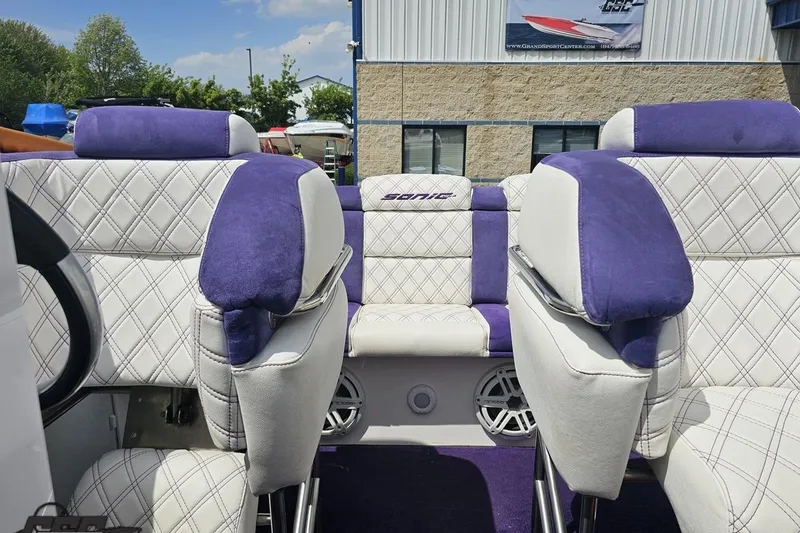 Slide: The Image of Luxurious interior of 2003 Sonic USA 31SS boat with purple and white seating. - 92