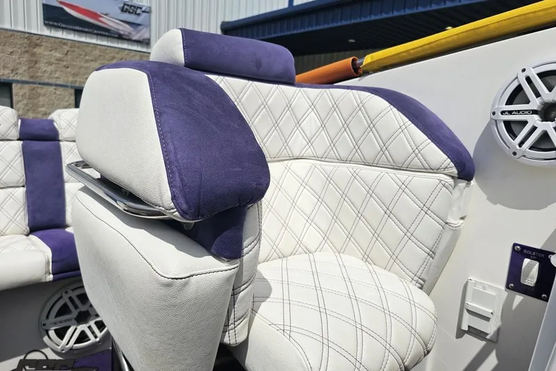 Slide: The Image of Luxury seating in a 2003 Sonic USA 31SS boat with purple and white upholstery. - 93