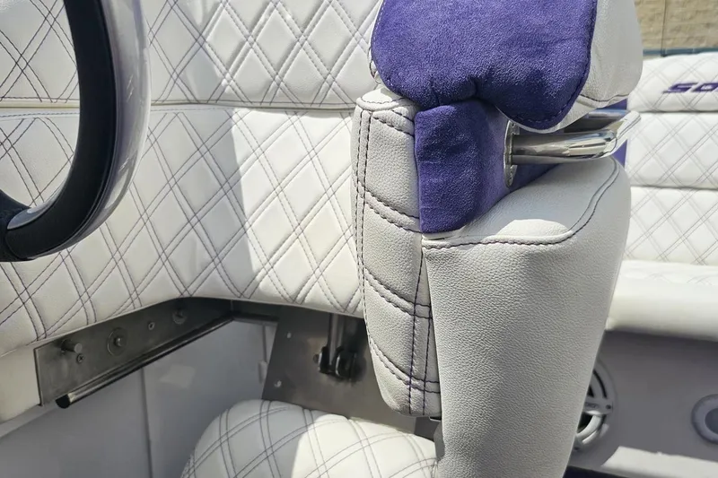 Slide: The Image of Close-up of 2003 Sonic USA 31SS boat interior with quilted white and purple upholstery. - 94