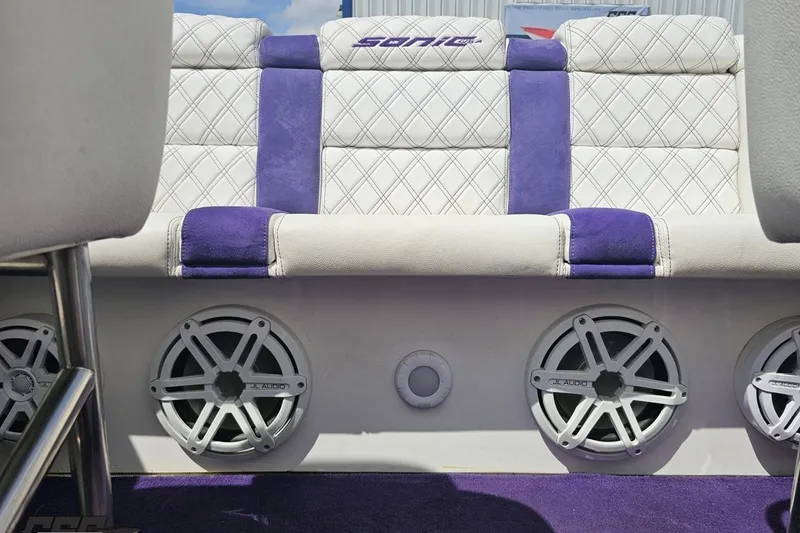 Slide: The Image of Luxury seating with JL Audio speakers in a 2003 Sonic USA 31SS boat interior. - 95