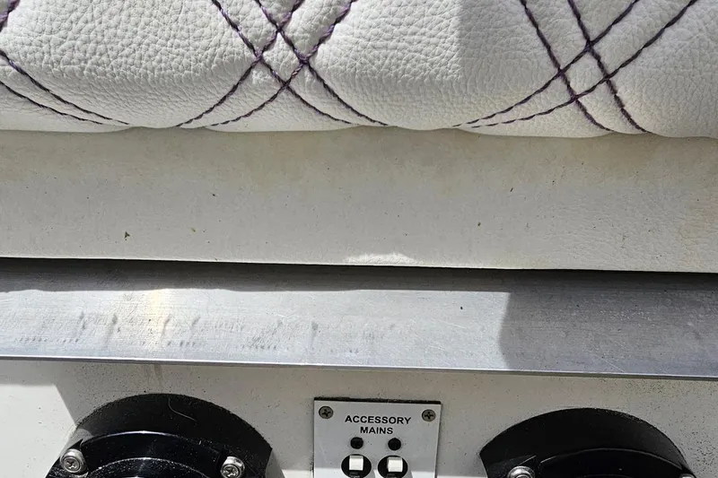 Slide: The Image of White leather seat with purple stitching, metal panel, and accessory mains switch on Sonic USA 31SS. - 96