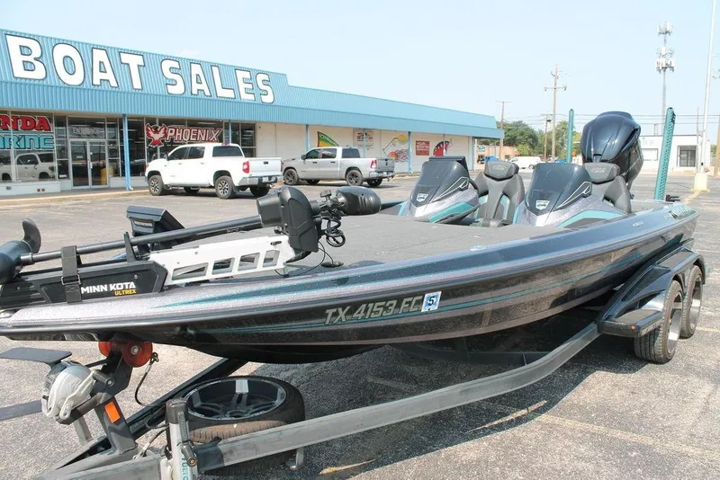 Slide: The Image of 2019 Skeeter FX21 LE boat displayed at a dealership, featuring Minn Kota Ultrex motor. - 2