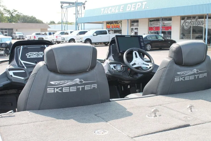Slide: The Image of 2019 Skeeter FX21 LE boat interior with branded seats and modern dashboard. - 7