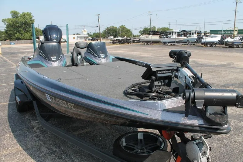 Slide: The Image of 2019 Skeeter FX21 LE bass boat with advanced navigation equipment in a parking lot. - 8