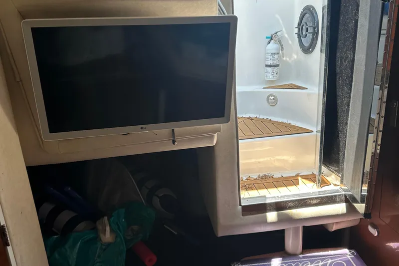 Slide: The Image of Interior of 2009 Sea Ray 270 Sundancer with TV and shower area. - 6