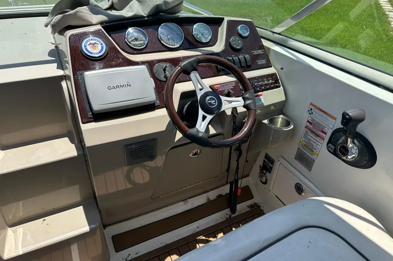 Slide: The Image of 2009 Sea Ray 270 Sundancer helm with Garmin GPS and wood-accented steering wheel. - 9