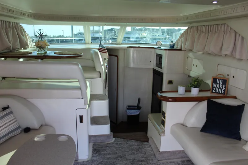 Slide: The Image of Interior of 1997 Sea Ray 400 Sedan Bridge yacht with cozy seating and decor. - 12