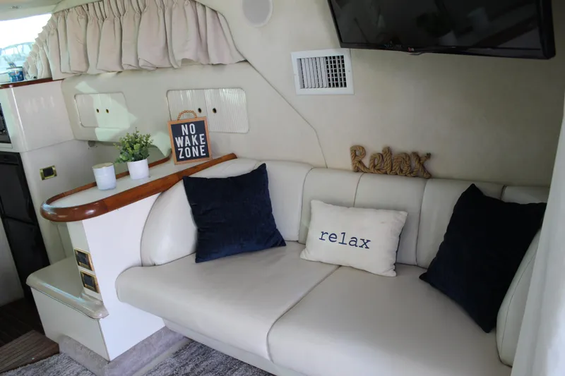 Slide: The Image of Interior of 1997 Sea Ray 400 Sedan Bridge with cozy seating and nautical decor. - 14