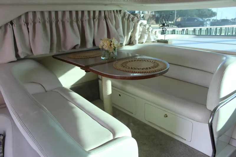 Slide: The Image of Interior of 1997 Sea Ray 400 Sedan Bridge with elegant dining area and plush seating. - 17