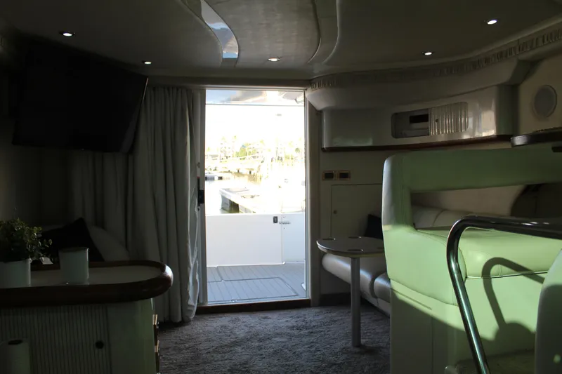 Slide: The Image of Interior of 1997 Sea Ray 400 Sedan Bridge yacht with modern furnishings and natural light. - 20