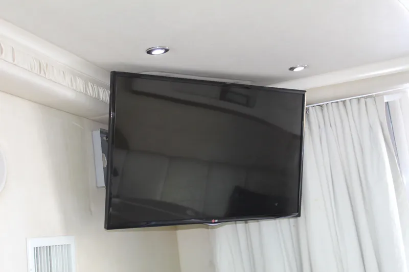 Slide: The Image of Flat-screen TV mounted in a 1997 Sea Ray 400 Sedan Bridge yacht interior. - 21