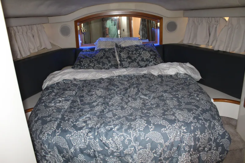 Slide: The Image of Luxurious bedroom interior of 1997 Sea Ray 400 Sedan Bridge yacht with floral bedding. - 22