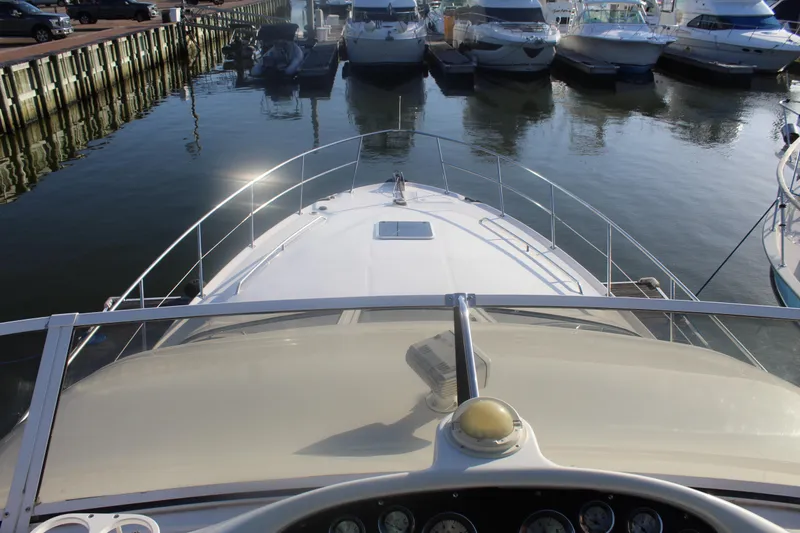Slide: The Image of 1997 Sea Ray 400 Sedan Bridge yacht docked at marina, view from helm. - 32