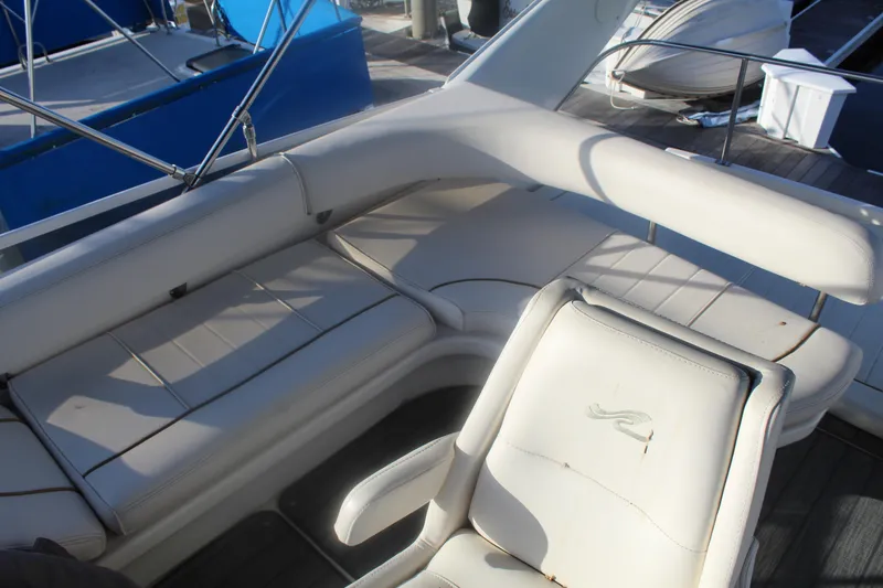 Slide: The Image of 1997 Sea Ray 400 Sedan Bridge interior with white seating and helm chair. - 33