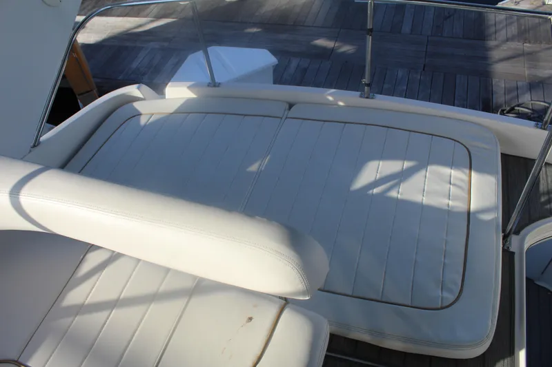 Slide: The Image of White cushioned seating on 1997 Sea Ray 400 Sedan Bridge yacht deck. - 34