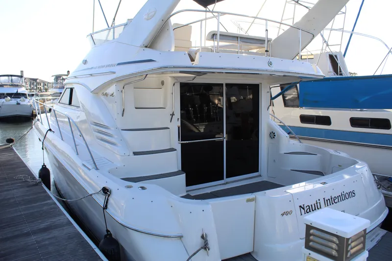 Slide: The Image of 1997 Sea Ray 400 Sedan Bridge yacht docked at marina, rear view. - 4