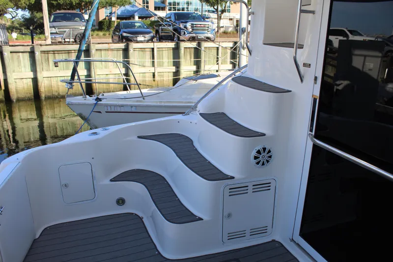 Slide: The Image of 1997 Sea Ray 400 Sedan Bridge yacht steps and deck area. - 9