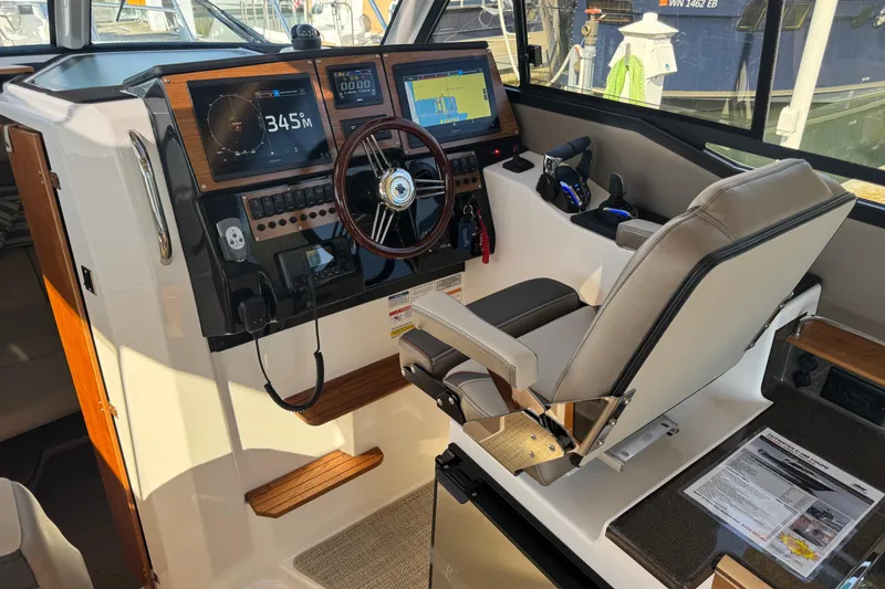 Slide: The Image of 2026 Cutwater C-288 Coupe helm with advanced navigation displays and comfortable captain's chair. - 11