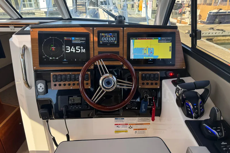Slide: The Image of Helm of 2026 Cutwater C-288 Coupe with advanced navigation displays and controls. - 12