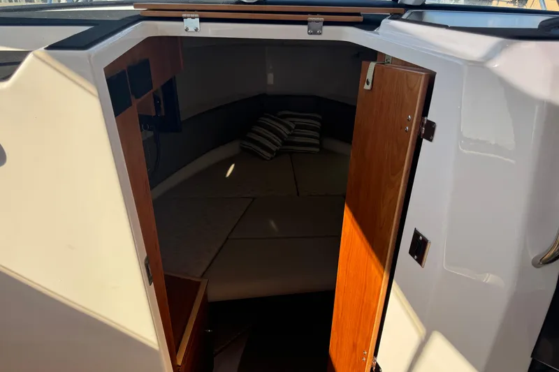 Slide: The Image of Interior cabin view of 2026 Cutwater C-288 Coupe, featuring cozy seating and wooden door. - 14