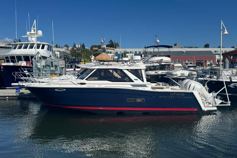 Slide: The Image of 2026 Cutwater C-288 Coupe boat docked in marina, featuring sleek design and modern amenities. - 4