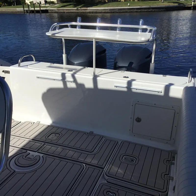 Slide: The Image of 2004 Century 3200 Center Console boat interior with dual engines on a sunny day. - 14