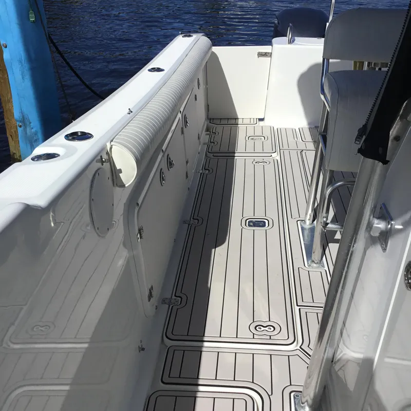 Slide: The Image of 2004 Century 3200 Center Console boat interior with sleek deck design. - 16