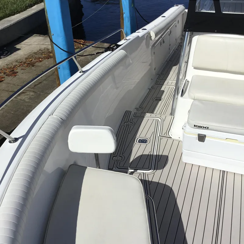 Slide: The Image of 2004 Century 3200 Center Console boat interior with cushioned seating and deck details. - 18