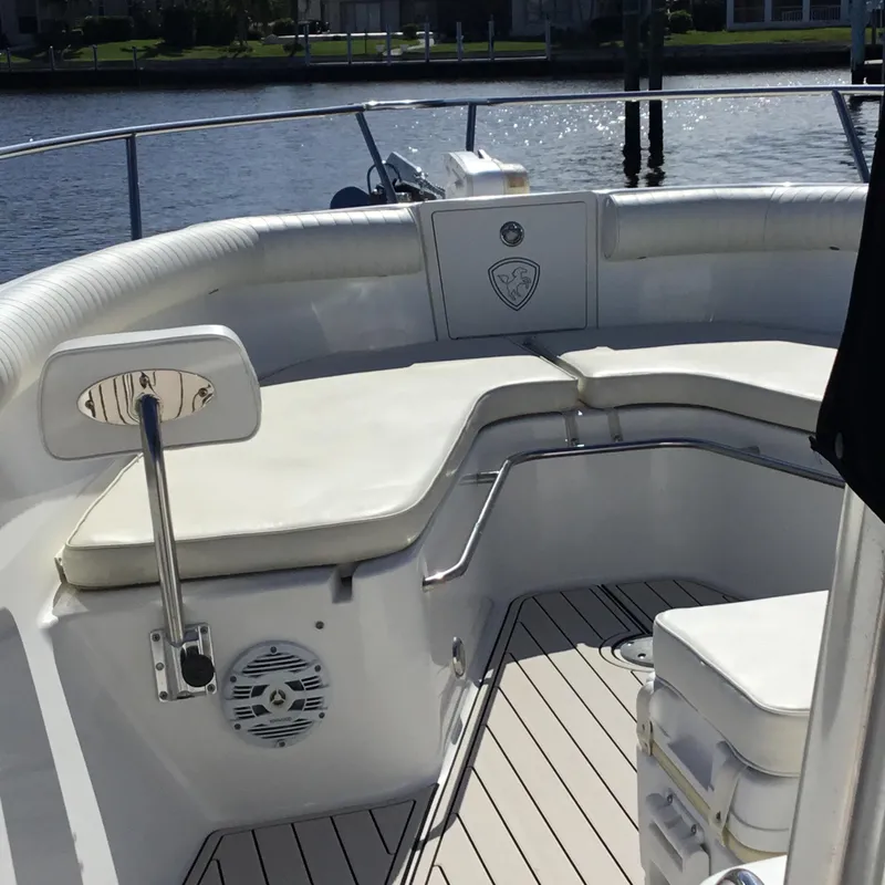 Slide: The Image of 2004 Century 3200 Center Console boat with cushioned seating and sleek design on the water. - 20