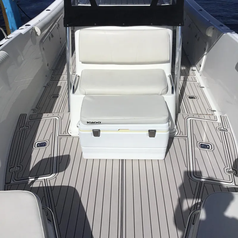 Slide: The Image of 2004 Century 3200 Center Console boat interior with seating and Igloo cooler. - 21