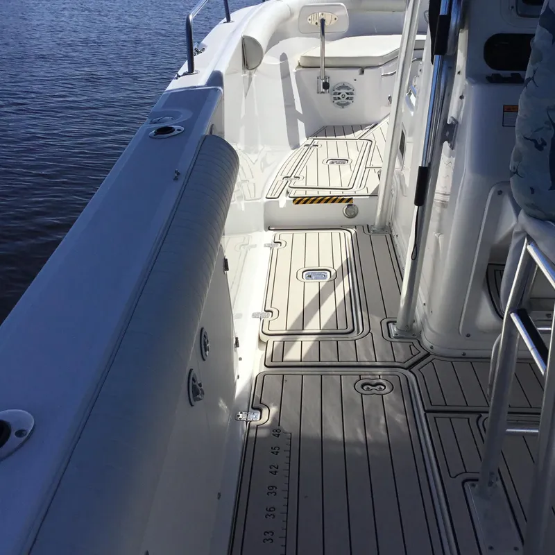 Slide: The Image of 2004 Century 3200 Center Console boat interior with sleek deck design and seating. - 23