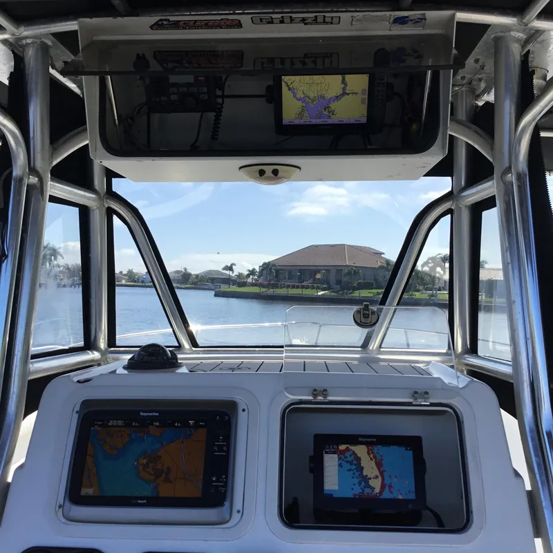 Slide: The Image of Interior view of a 2004 Century 3200 Center Console boat with navigation screens. - 33