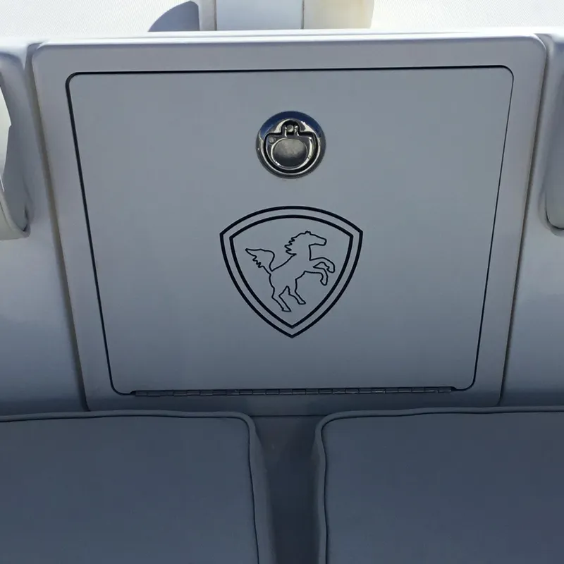 Slide: The Image of 2004 Century 3200 Center Console boat compartment with horse emblem and latch. - 35