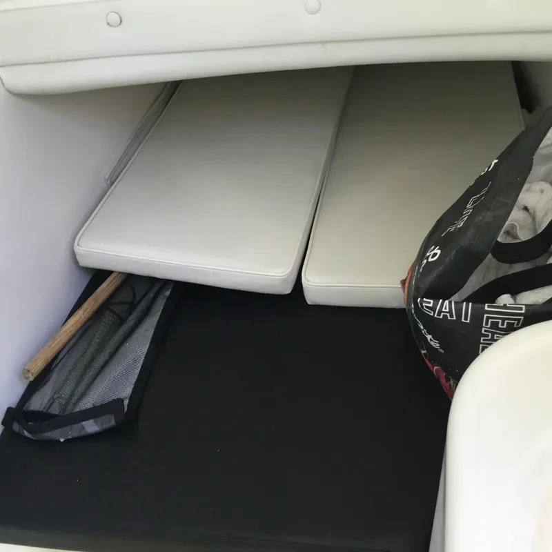 Slide: The Image of Interior storage area of a 2004 Century 3200 Center Console boat with cushions and a bag. - 42