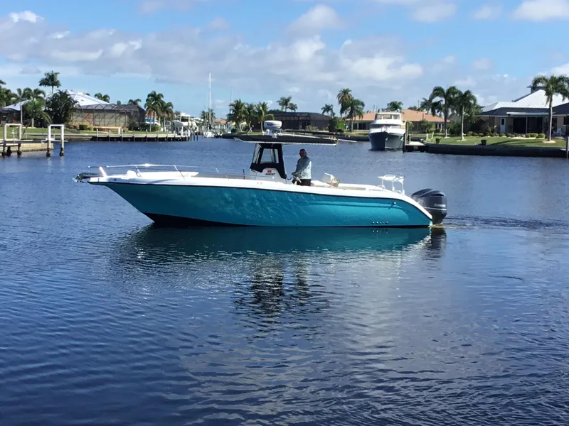 Slide: The Image of 2004 Century 3200 Center Console boat cruising on a calm waterway. - 46