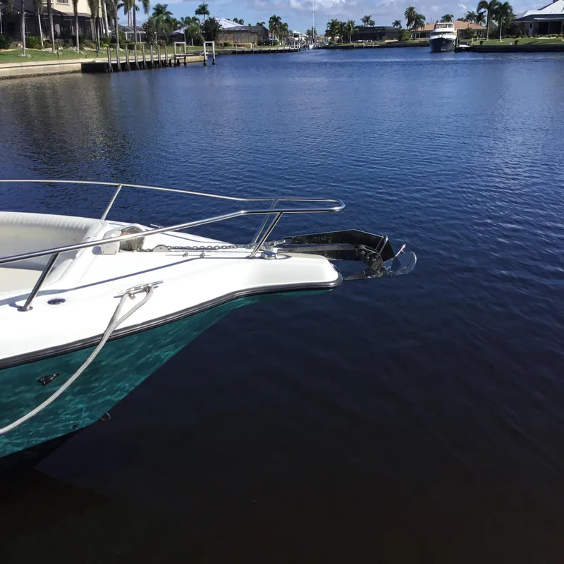 Slide: The Image of 2004 Century 3200 Center Console boat docked on a calm waterfront. - 7