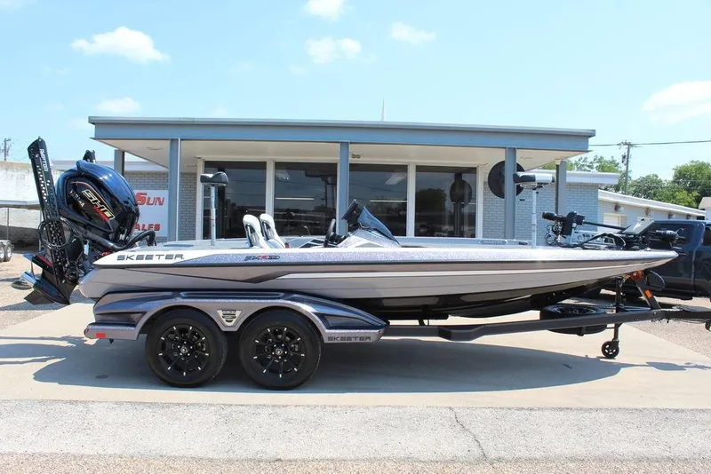 The Image of 2026 Skeeter FXR20 FLEX boat on trailer, parked outside dealership. - 0
