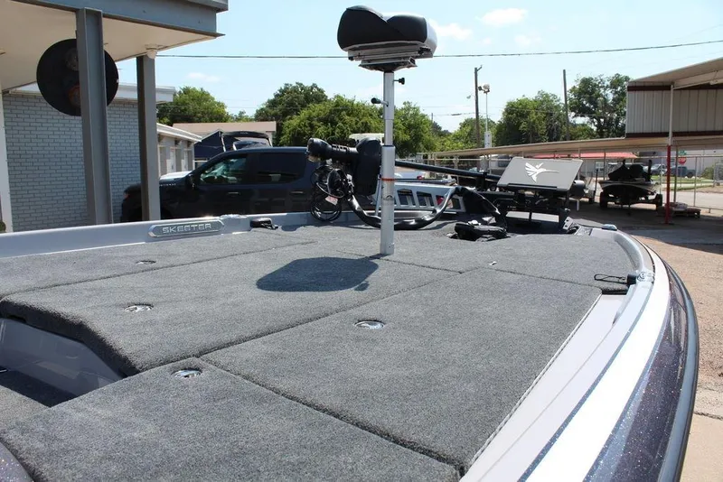 Slide: The Image of 2026 Skeeter FXR20 FLEX boat with spacious deck and modern seating at a dealership. - 14