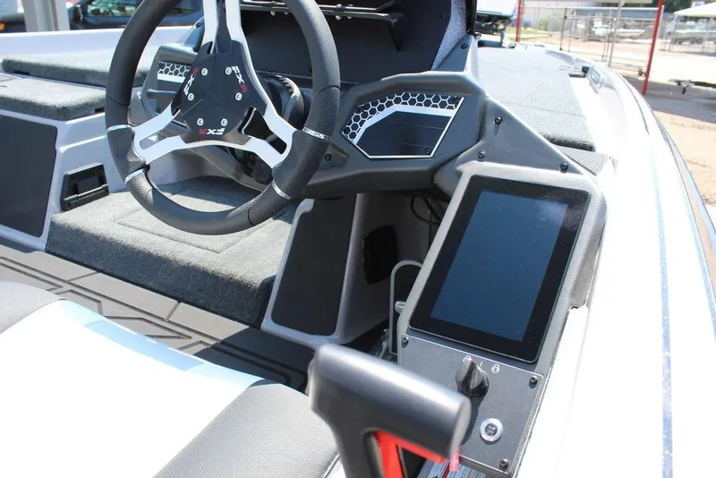Slide: The Image of 2026 Skeeter FXR20 FLEX boat interior with modern steering and seating. - 19