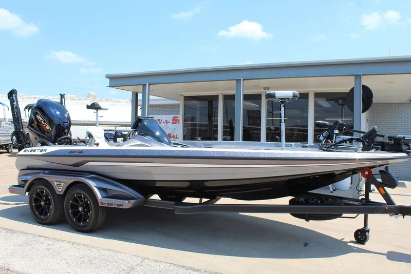 Slide: The Image of 2026 Skeeter FXR20 FLEX boat dashboard with steering wheel and touchscreen display. - 20