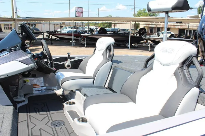 Slide: The Image of 2026 Skeeter FXR20 FLEX boat on trailer at dealership under clear sky. - 9