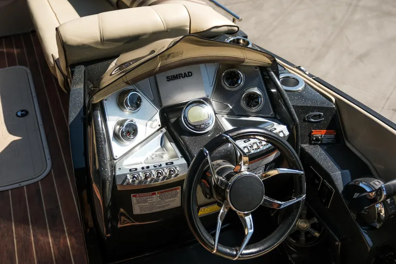 Slide: The Image of 2018 Crest Savannah 250 SLS boat dashboard with steering wheel and control panel. - 10