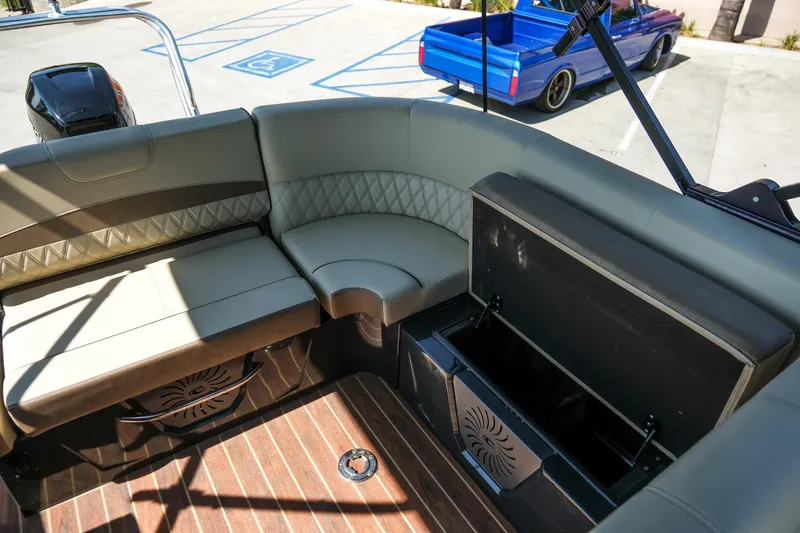 Slide: The Image of Luxurious seating on 2018 Crest Savannah 250 SLS boat with storage compartment open. - 13