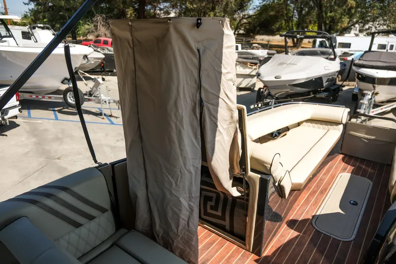 Slide: The Image of 2018 Crest Savannah 250 SLS pontoon boat interior with seating and privacy curtain. - 15