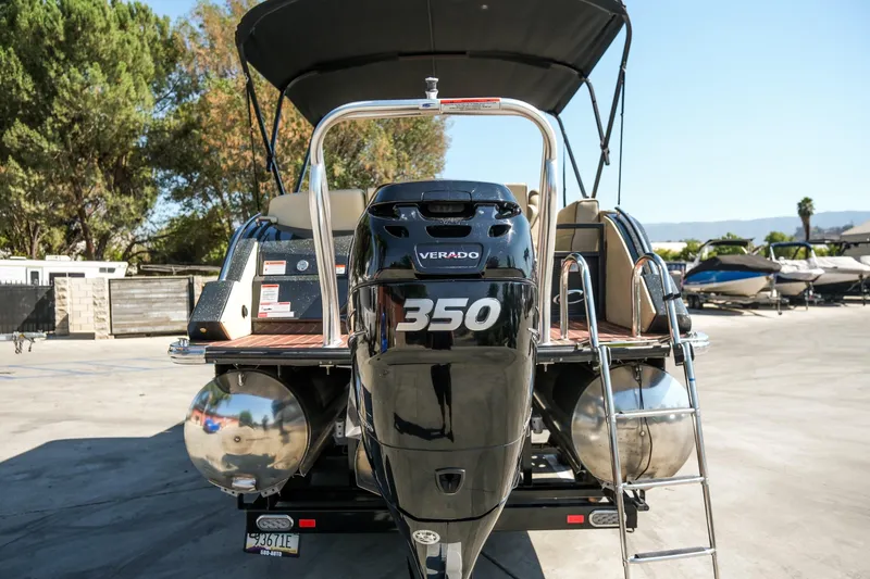Slide: The Image of 2018 Crest Savannah 250 SLS pontoon boat with powerful Verado 350 engine, docked outdoors. - 21