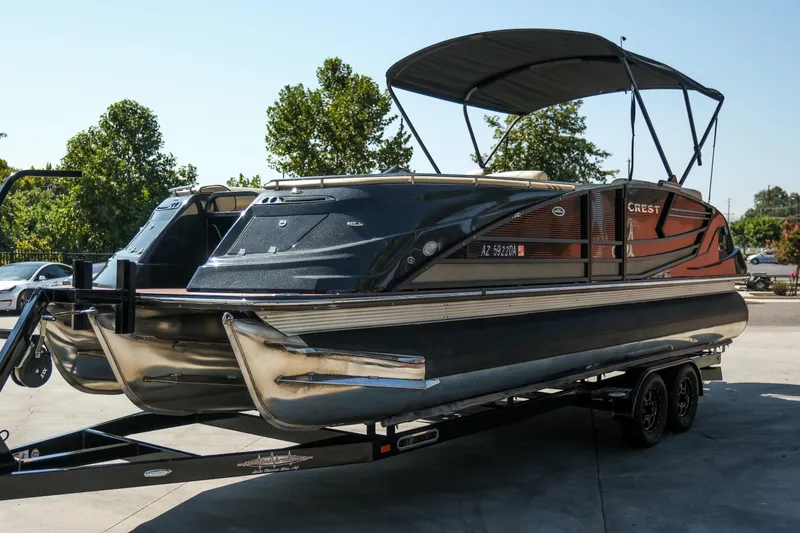 Slide: The Image of 2018 Crest Savannah 250 SLS pontoon boat on trailer, parked outdoors. - 4